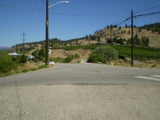 Crossing Naramata Road, trail continues on the other side, Kettle Valley Railway Penticton to Naramata, 2011-08.